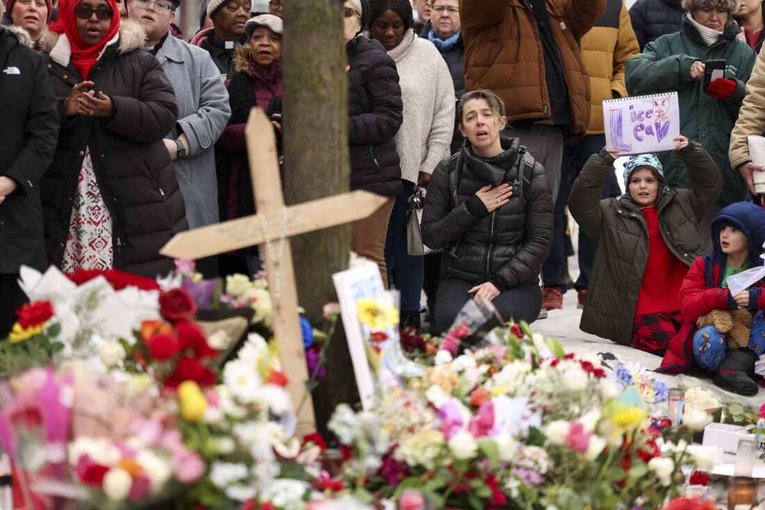 People gather at the street where 37-year-old Renee Nicole Good was shot and killed on Wednesday by a US Immigration and Customs Enforcement (ICE) agent in Minneapolis, Minnesota, on Thursday.