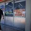 A 'We Accept Food Stamps' sign hangs in the window of a grocery store in Miami. 