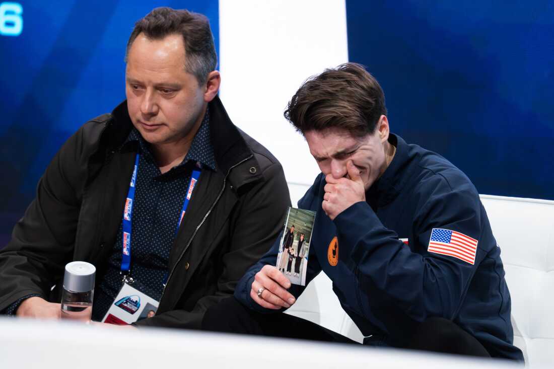 Maxim Naumov holds a photo of his parents while he waits for his scores after competing in the men’s short program competition during the 2026 U.S. Figure Skating Championships at the Enterprise Center on Thursday, Jan. 8, 2026, in St. Louis’ Downtown West neighborhood.