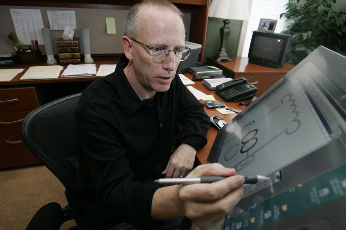 Scott Adams works on his comic strip in his California studio in 2006.  