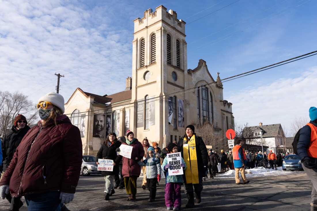 Rev. Ashley Horan and her daughter Eden, 5, march from St. Paul's-San Pablo Lutheran Church during a singing vigil in memory of Renee Nicole Good in Minneapolis Sunday, Jan. 11, 2026. 