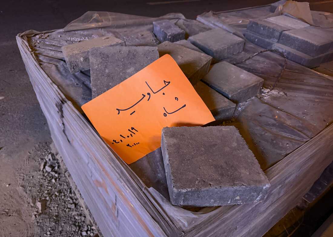 In this photo obtained by The Associated Press, a placard is placed on bricks that reads in Farsi, "Long live the Shah," referring to the Pahlavi dynasty that was toppled in the 1979 Islamic Revolution, during an anti-government protest in Tehran, Iran, Friday, Jan. 9, 2026.
