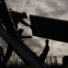 Workers install solar panels at a project this spring in Galena, Alaska.