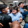 A Paraguayan woman whose relative was detained by federal agents scuffles with officers in the halls of immigration court at the Jacob K. Javits Federal Building in New York City in July.