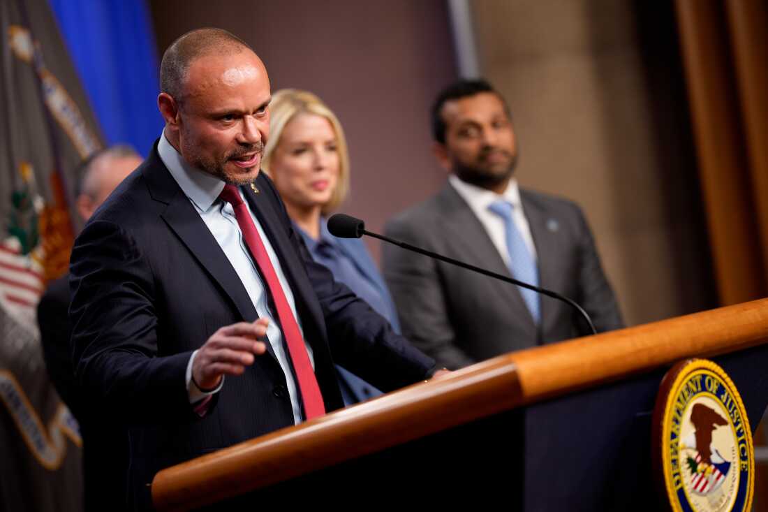 WASHINGTON, DC - DECEMBER 4: FBI Deputy Director Dan Bongino (L), accompanied by, Attorney General Pam Bondi (C), and FBI Director Kash Patel (R), speaks during a news conference on an arrest of a suspect in the January 6th pipe bomb case at the Department of Justice on December 4, 2025 in Washington, DC. Federal agents have arrested a suspect they are charging with placing two pipe bombs, which never exploded, the night before the January 6th, 2021 U.S. Capitol attack. (Photo by Andrew Harnik/Getty Images)