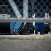 People detained by federal agents walk into a suburban Chicago ICE detention center in Broadview, Ill., on Sept. 19.