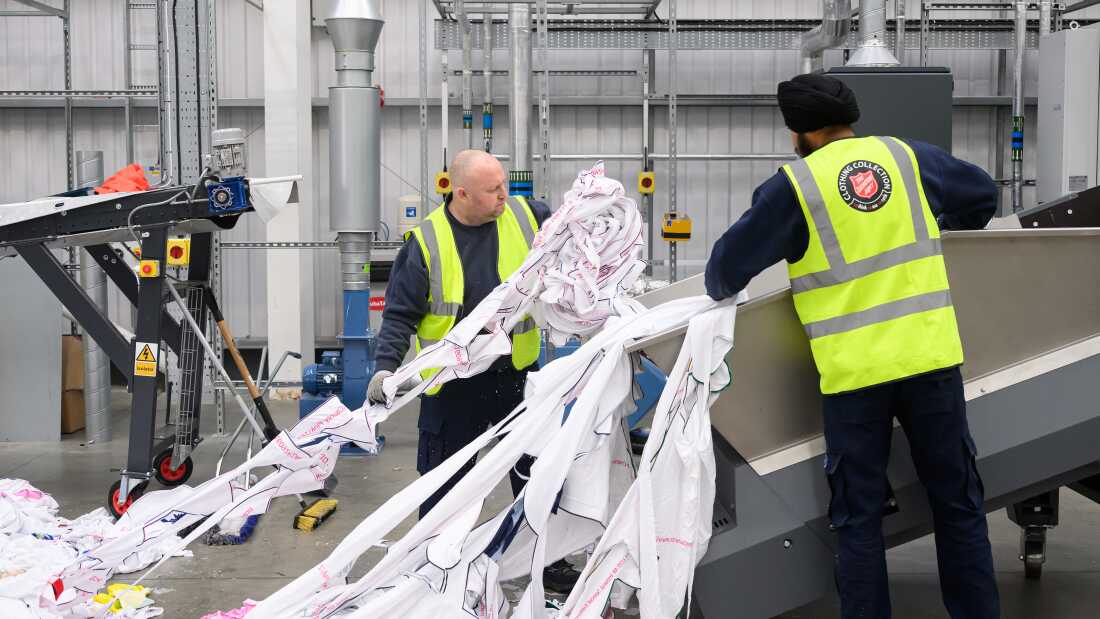 Workers load unwanted polyester textiles into the Project Re:Claim system, the first commercial-scale polyester recycling plant of its kind, last year in Kettering, England.