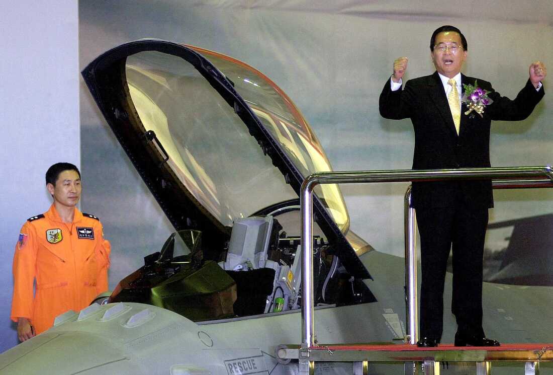 Taiwan's then-President Chen Shui-bian (right) gestures as he attends a ceremony in southern Chiayi airbase to put into force the island's first F-16 fighter wing, on Dec. 18, 2001. Chen warned of arch foe China's growing military threat and called for an arms buildup.