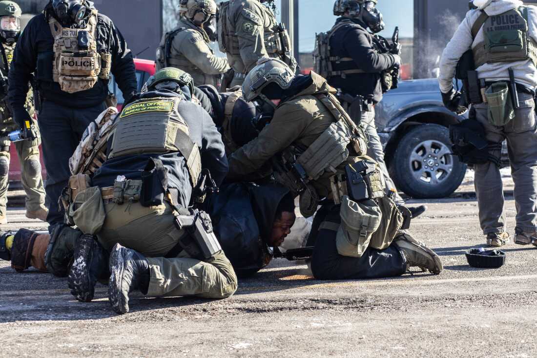 ICE and federal agents face off with Minneapolis residents and protesters following the fatal shooting of a local resident earlier in the day near Nicollet Avenue and West 26th Street in south Minneapolis, Minnesota, Jan. 24, 2026. Photographed by Erin Trieb for NPR.
