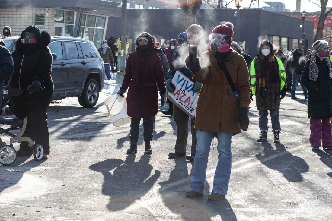 ICE and federal agents face off with Minneapolis residents and protesters following the fatal shooting of a local resident earlier in the day near Nicollet Avenue and West 26th Street in south Minneapolis, Minnesota, Jan. 24, 2026. Photographed by Erin Trieb for NPR.