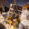 A sign for Alex Pretti, who was killed earlier in the day by a U.S. Border Patrol officer, is displayed during a vigil Saturday, Jan. 24, 2026, in Minneapolis. Zaydee Sanchez for NPR