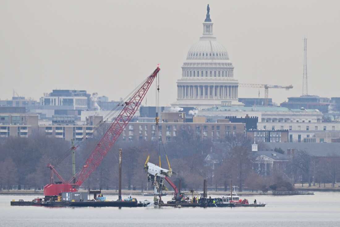 A crane removes airplane wreckage from the Potomac River, where American Airlines flight 5342 collided with a U.S. Army helicopter, near Ronald Reagan Washington National Airport, on February 3, 2025. The collision killed 67 people and was the deadliest U.S. aviation accident since 2001.