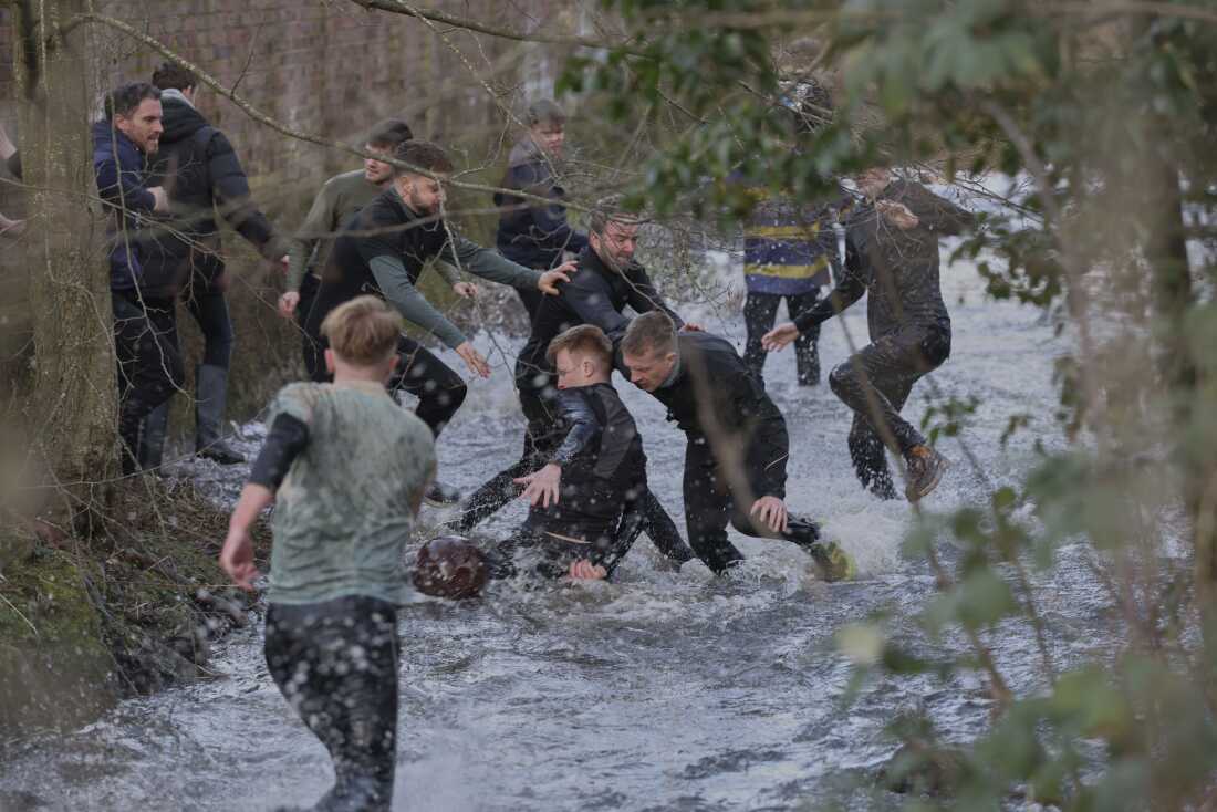 Players compete for the ball in the Henmore Brook during the annual Shrovetide medieval hugball soccer that is match played in Ashbourne, England, on March 4, 2025, which has been played in England from the reign of King Henry II.