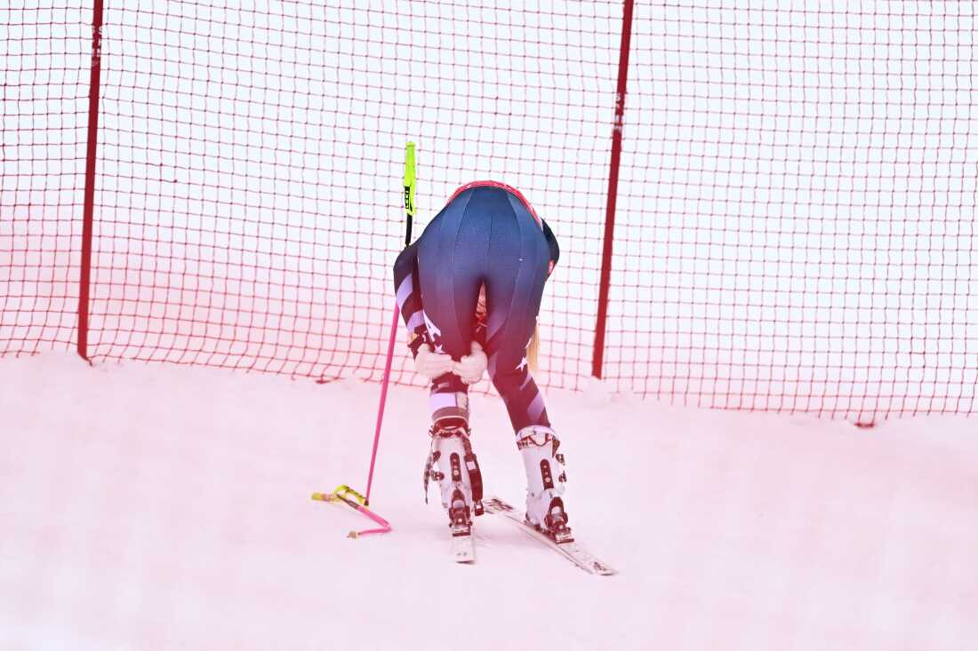 Lindsey Vonn holds the back of her left knee after crashing in the women's downhill in Crans Montana, Switzerland on Friday. It was her final tune-up race ahead of the 2026 Winter Olympics.