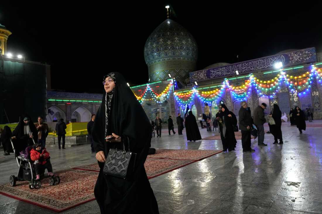 A woman walks through the Shiite Saints Abdulazim and Taher shrine in Shahr-e-Ray, south of Tehran, Iran, Thursday, Jan. 29, 2026.