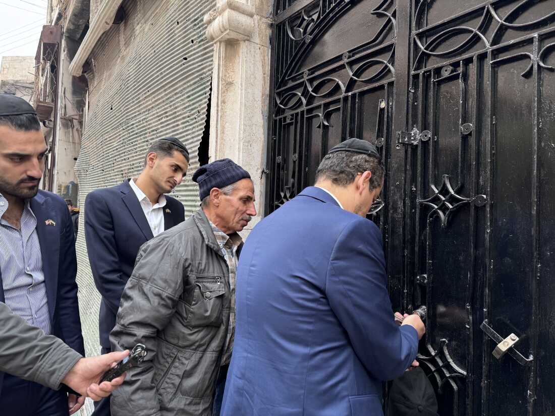 Henry Hamra unlocks the door of a synagogue in Aleppo