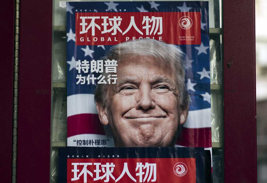 An advertisement for a magazine featuring then-President-elect Donald Trump on its cover, at a newsstand in Shanghai on December 14, 2016. The magazine cover shows Trump's face with a wide smile and a U.S. flag in the background.