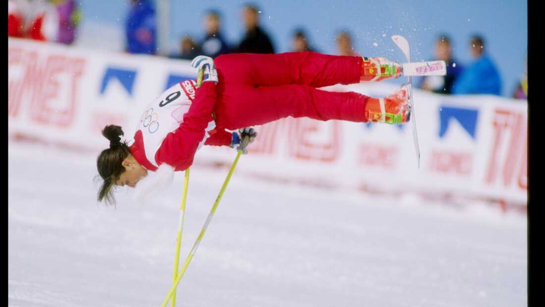 Cathy Fechoz of France, wearing a red ski suit, is caught midair while performing her routine during the ski ballet competition at the Olympic Games in Albertville, France, in 1992. 