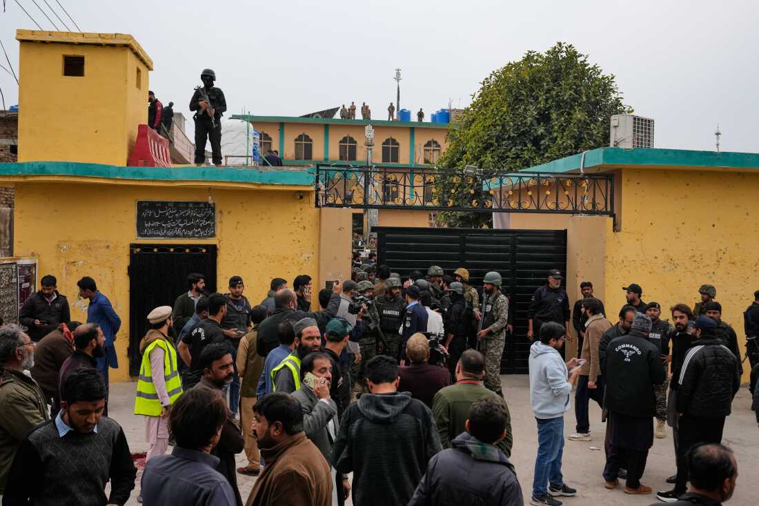Pakistani security officers and rescue worker gather at the site of a bomb explosion at a Shiite mosque, in Islamabad, Pakistan.