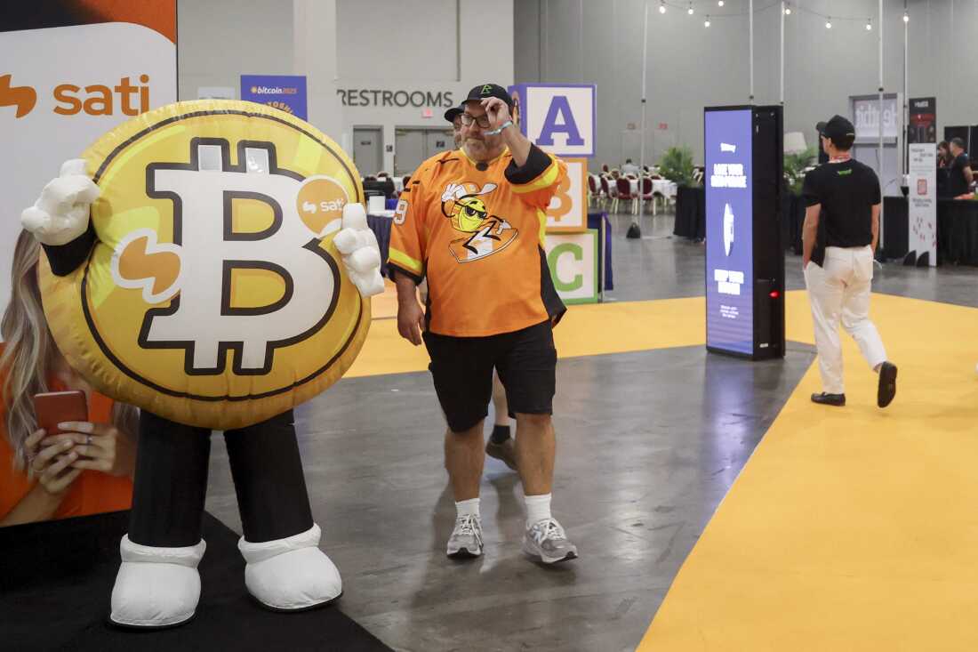 Attendees walk past the Bitcoin mascot during The Bitcoin Conference at The Venetian Las Vegas in Las Vegas on May 27, 2025.