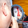 Rob Gann puts on his clown makeup in the backstage locker room at the Adirondack Stampede Rodeo in Glens Falls, N.Y.